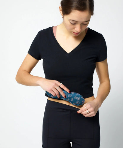 Woman inserting Uterine Ice/Heat Pack into VieWear Leggings